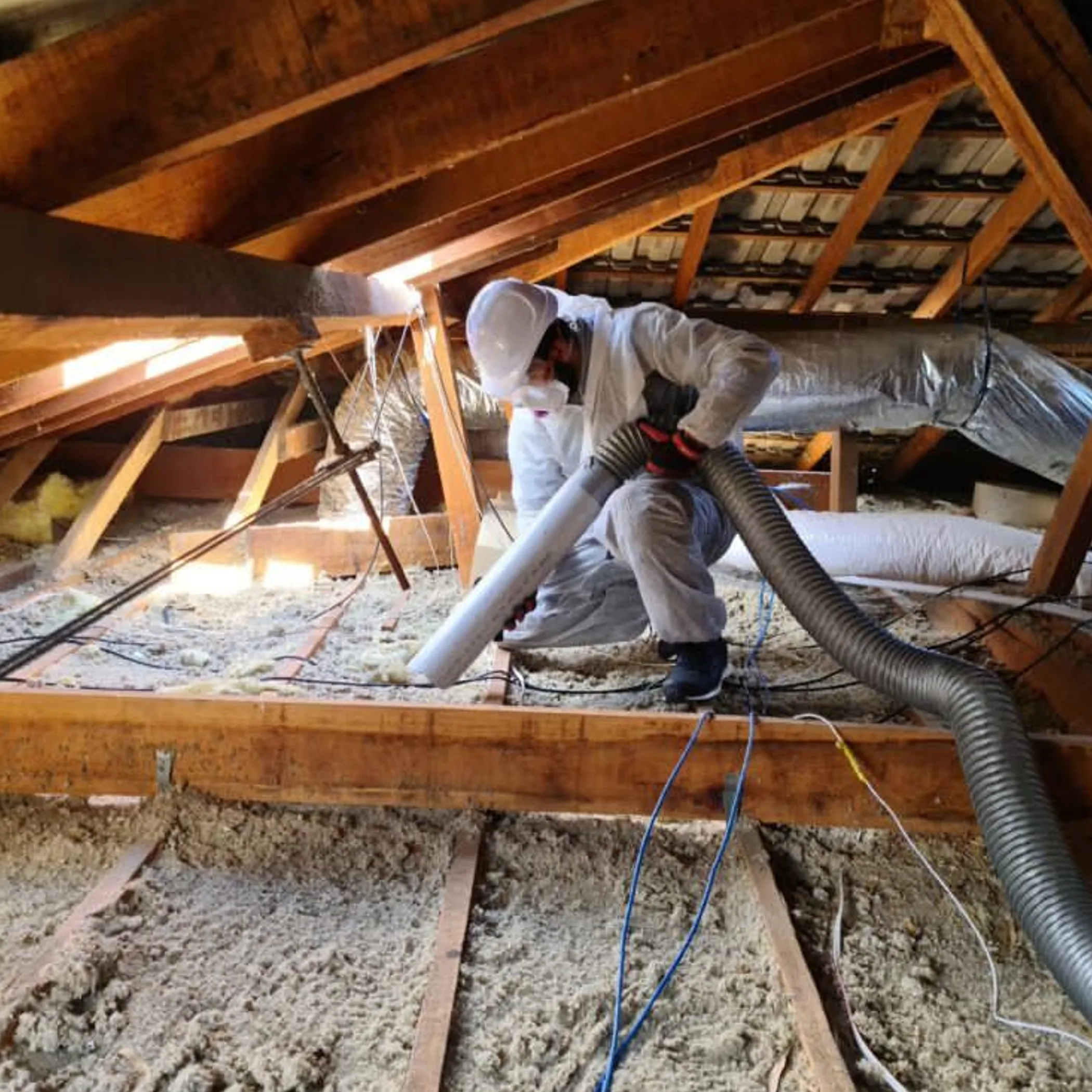 worker installing ceiling insulation
